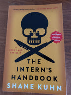 The Intern's Handbook: A Thriller by Shane Kuhn paperback (like new)