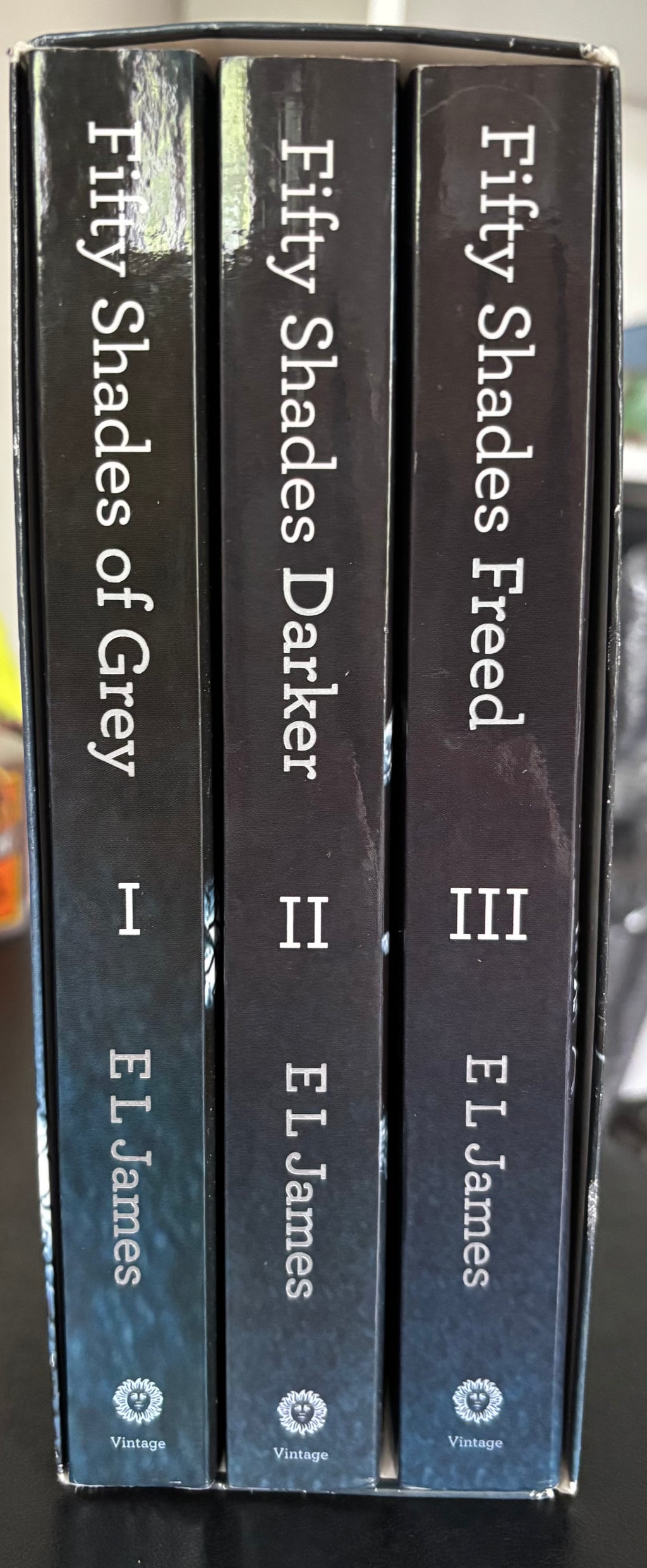 Fifty Shades Trilogy (Fifty Shades of Grey, Fifty Shades Darker, Fifty Shades Freed) by E.L. James paperback (rescued)
