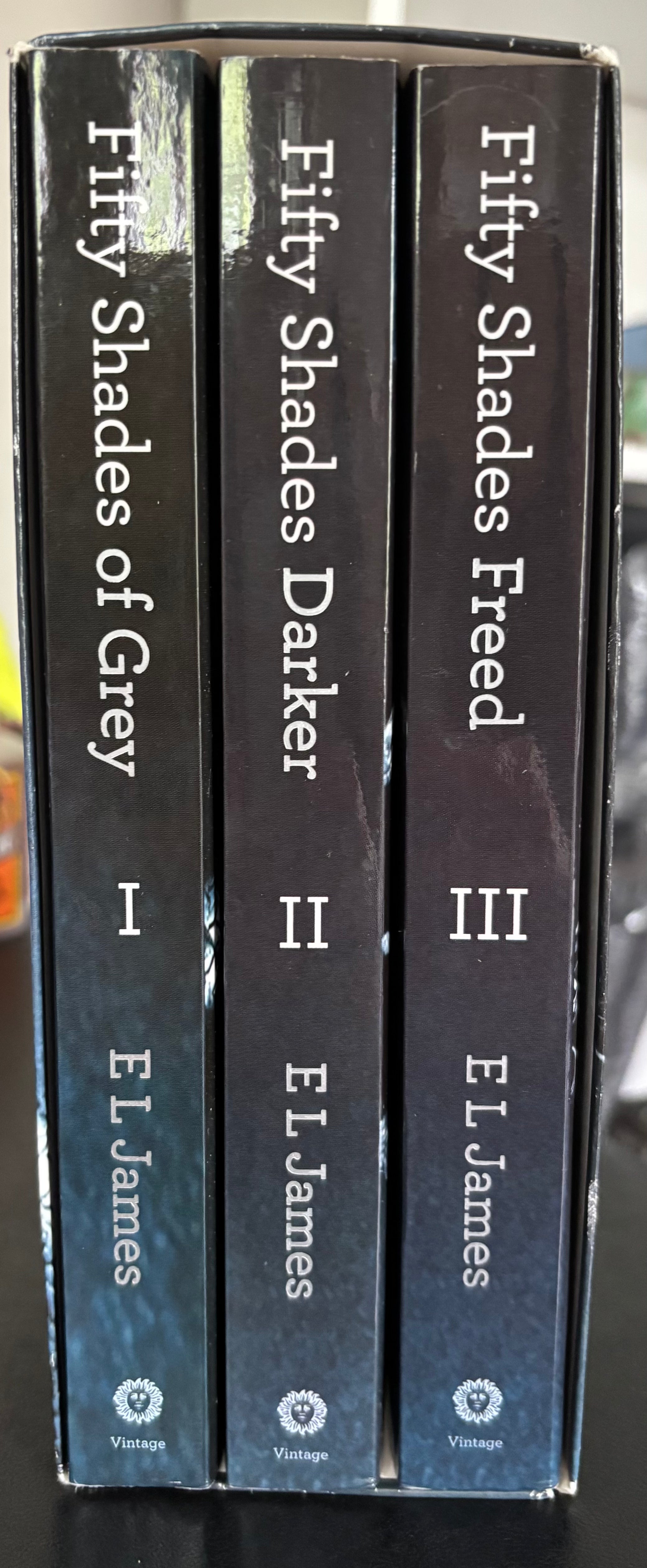 Fifty Shades Trilogy (Fifty Shades of Grey, Fifty Shades Darker, Fifty Shades Freed) by E.L. James paperback (rescued)