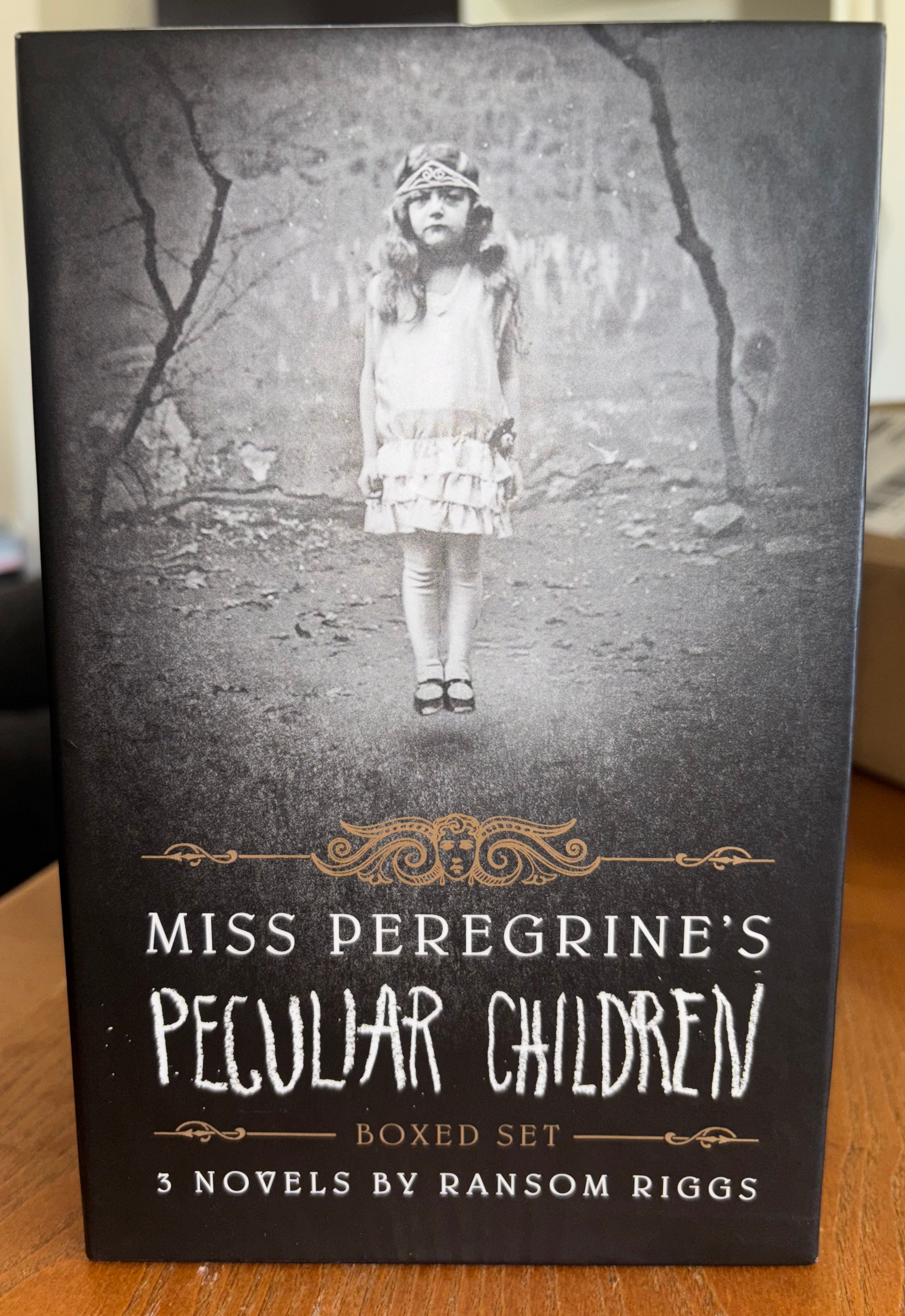 3 book box set, Miss Peregrine's Home for Peculiar Children, Hollow Ciity, and Library of Souls by Ransom Riggs (the first 3 books of Miss Peregrine‘s Peculiar Children series) plus additional pictures hardcover YA (like new)